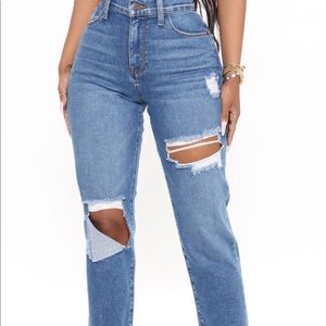 Medium blue wash mom jeans, features a rolled cuff.